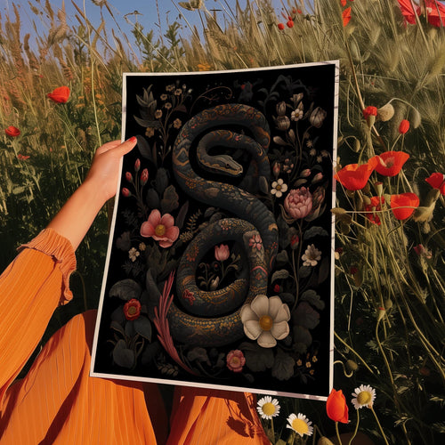 a woman holding a picture of a snake in a field of flowers